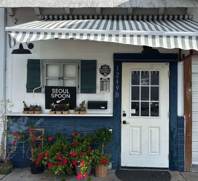 Seoul Spoon storefront at 1249 Blalock Rd with a striped awning and blue door